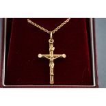 A boxed hallmarked 9 carat gold crucifix pendant, suspended from a twisted rope chain,