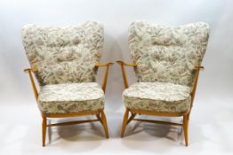 A pair of Ercol blonde wood armchairs,