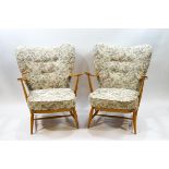 A pair of Ercol blonde wood armchairs,