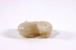 A Chinese white jade carving of a recumbent dog, 4.