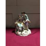 A 20th century Sitzendorf porcelain figural group of a seated lady and her lover,