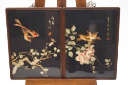 A pair of 20th century Japanese silkwork pictures of birds flying over a flowering branch,