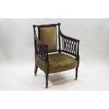 A 19th century mahogany elbow chair with upholstered back and seat and pierced lattice arms,