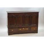 An 18th century oak mule chest with two cupboard doors bearing carved ogee shaped arches above