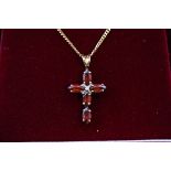 A hallmarked 9ct gold cross pendant set with five marquise cut garnet (5.8mm x 3.