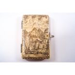 A 19th century Dieppe ivory card case with penwork detail of a harbour town and mountain landscape,