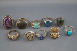 A selection of ten silver dress rings set with multiple stones. Total Gross weight : 65.