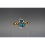 A three stone ring set with blue topaz and diamonds. hallmarked 9ct gold, London, 1989. 'A & G' 2.