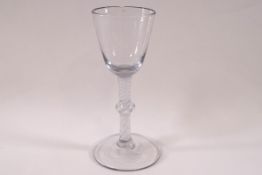 An 18th century drinking glass, the conical bowl on a double spiral twist stem with single knop,
