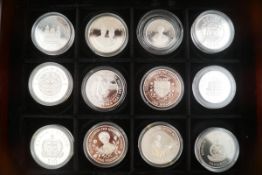 Twelve H M Queen Elizabeth the Queen Mother official coin collection, mostly crown sized coins,