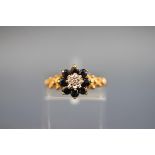 A hallmarked 9 carat gold cluster ring set with eight round sapphires measuring 2.