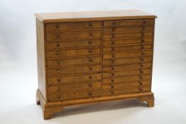 A pine collector's chest of twenty two drawers,
