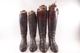Two pairs of gentleman's black leather riding boots with wooden trees,