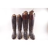 Two pairs of gentleman's black leather riding boots with wooden trees,