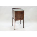 An Edwardian mahogany bow front pot cupboard with two shelves,