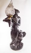 A large plaster electrified lamp, modelled as a robed maiden holding aloft a torch,