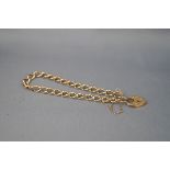 A yellow gold curb bracelet, padlock and safety chain. Hallmarked 9ct gold, London, 1991. 8.