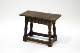 A 17th century style oak joint stool with carved detail to side and legs,