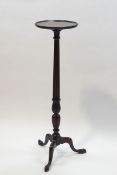An Edwardian mahogany torchere on carved fluted column and claw feet,