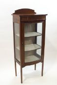 An Edwardian mahogany bow fronted display cabinet with two adjustable shelves,