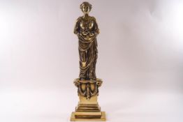 A brass doorstop in the form of a Classical lady,