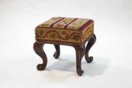 A Victorian square rosewood footstool with woolwork seat on carved cabriole legs,