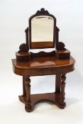 A Victorian mahogany dressing table with swing frame mirror and three drawers on turned front legs