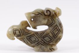 A Chinese Han Dynasty hardstone toggle, carved as a mythical beast,
