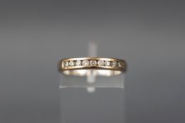 A white gold ring set with nine round brilliant diamonds. Shank stamped DIA. Hallmarked 18ct gold.