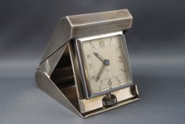 An Art Deco style travelling clock with eight day Swiss movement,