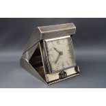 An Art Deco style travelling clock with eight day Swiss movement,