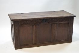 A 17th century oak triple panelled coffer with carved frieze,