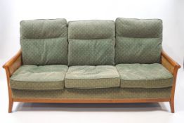 An Ercol Bergere three piece suite with green flower patterned upholstery, sofa 185cm wide,