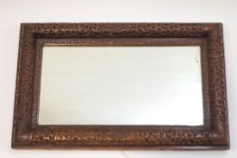A Chinese carved hardwood framed wall mirror, 57cm x 35.