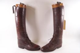 A pair of early 20th century brown leather riding boots and wooden trees (formerly from Dinder