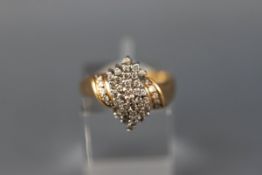 A yellow and white gold abstract cluster ring set with forty five round brilliant diamonds.
