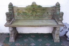 A reconstituted stone garden bench in the Egyptian style (weathered),