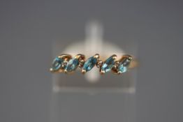 A yellow gold half hoop ring set with blue topaz and diamond. Hallmarked 9ct gold, Birmingham.