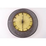 A mid-20th century Atlantic electric wall clock with pierced metal surround,