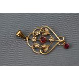 An Edwardian yellow gold pendant set with synthetic rubies and seed pearls. Stamped 9ct. 2.