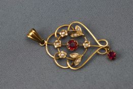 An Edwardian yellow gold pendant set with synthetic rubies and seed pearls. Stamped 9ct. 2.