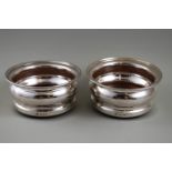 A pair of silver mounted coasters with turned wood bases, London 1964 by C J Vander, 9.