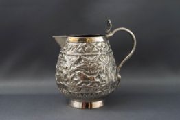 A late 19th century Indian white metal sparrow beak milk jug, the handle in the form of a cobra,