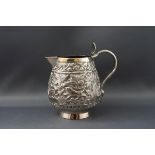 A late 19th century Indian white metal sparrow beak milk jug, the handle in the form of a cobra,