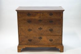 A George III walnut chest of two short over three long drawers,