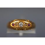 A yellow gold half hoop ring set with three diamonds and two rubies.