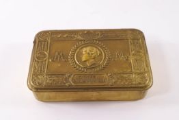 A 1914 Christmas tin containing a Victory medal and original cracker biscuit