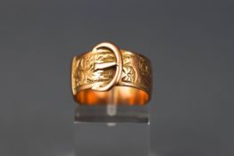 A yellow gold buckle ring. 9.00mm shank. Hallmark worn - tests indicate 18ct.