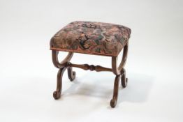 A Victorian mahogany X-frame footstool with padded seat,