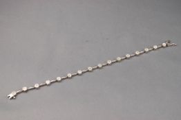 A white gold bracelet having sixteen diamond clusters, 2ct weight in total,